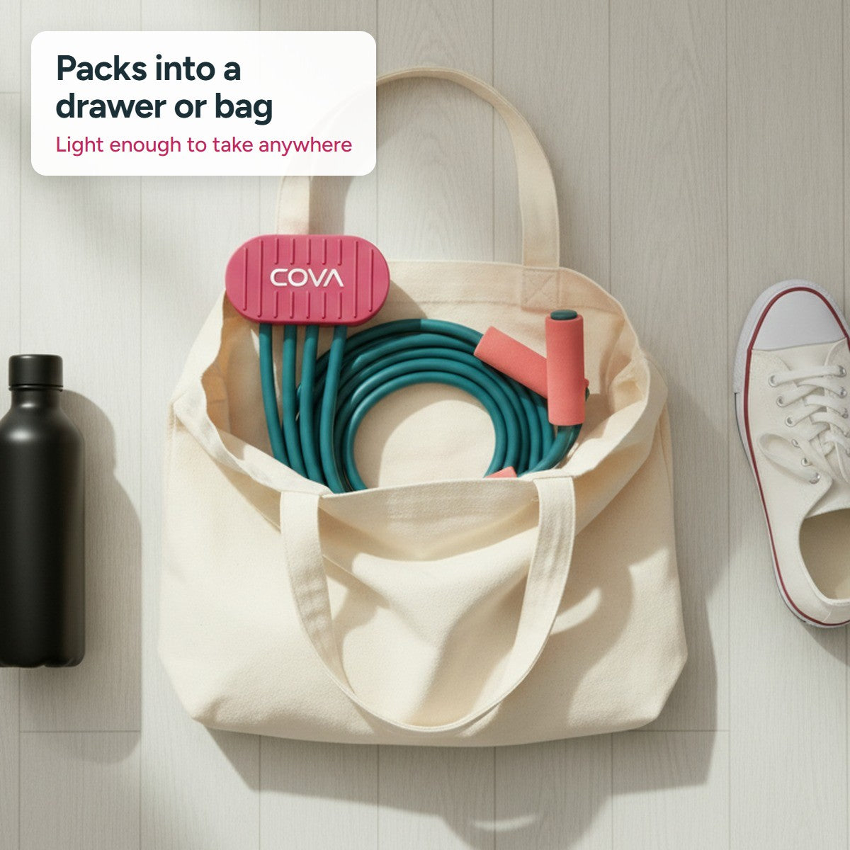 COVA band coiled in a canvas tote bag next to sneakers and a water bottle
